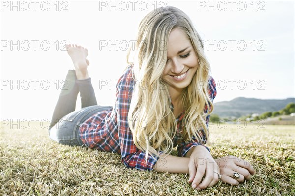 Caucasian woman laying in park