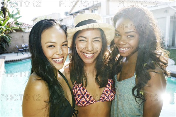 Women hugging near swimming pool