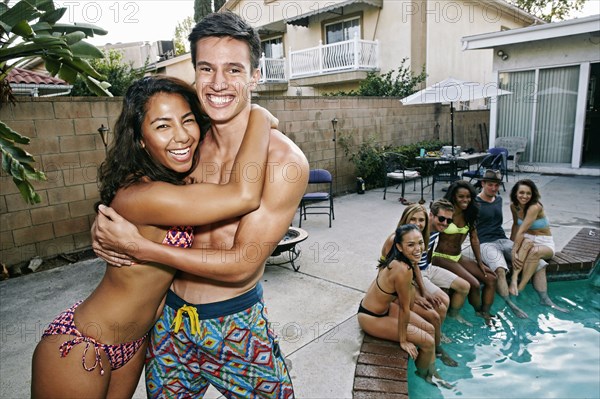 Couple hugging near swimming pool