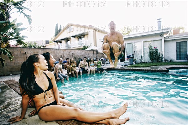 Man jumping into swimming pool