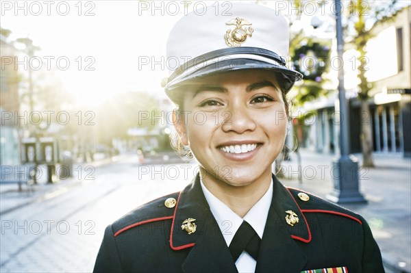 Asian soldier smiling outdoors