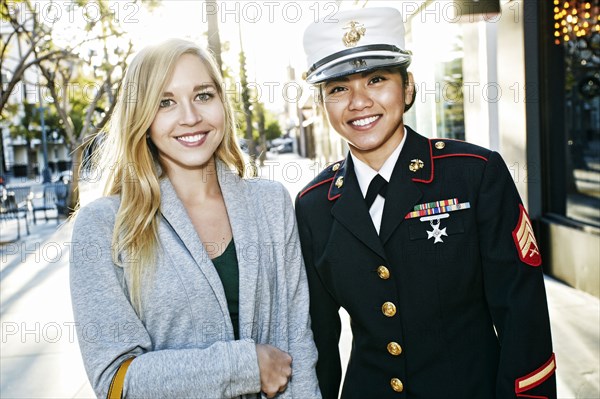 Soldier smiling with friend outdoors