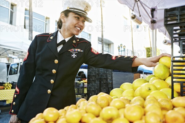 Asian soldier shopping in farmers market