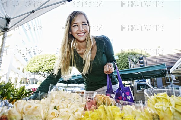 Caucasian woman shopping in flower market