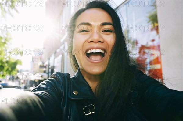 Asian woman smiling outdoors