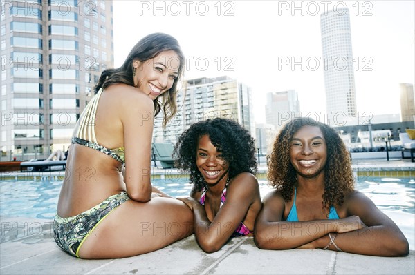 Smiling women enjoying urban swimming pool