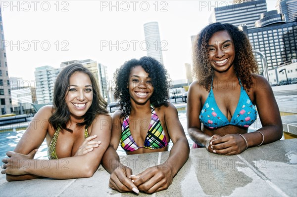 Smiling women enjoying urban swimming pool