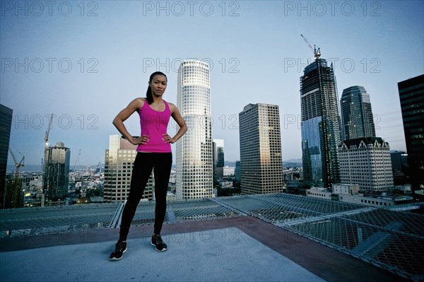 Mixed Race woman standing on urban rooftop