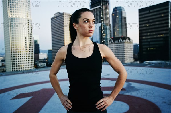 Caucasian woman resting on urban rooftop