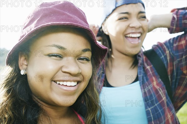 Mixed Race sisters laughing outdoors