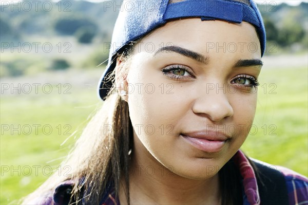 Confident Mixed Race woman wearing backward baseball cap