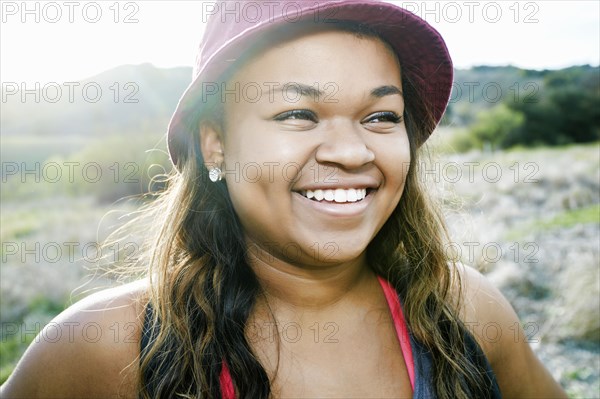 Mixed Race teenager smiling in field