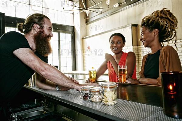 Bartender talking to customers