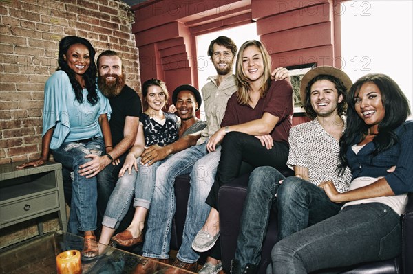 Smiling friends posing in bar