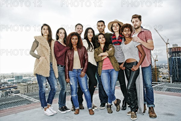 Stylish friends posing on urban rooftop