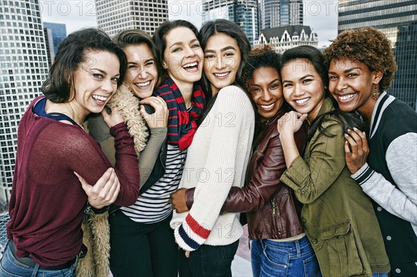 Stylish women posing on urban rooftop