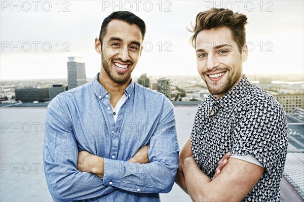 Stylish men posing on urban rooftop