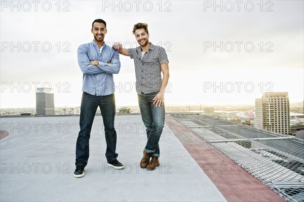 Stylish men posing on urban rooftop