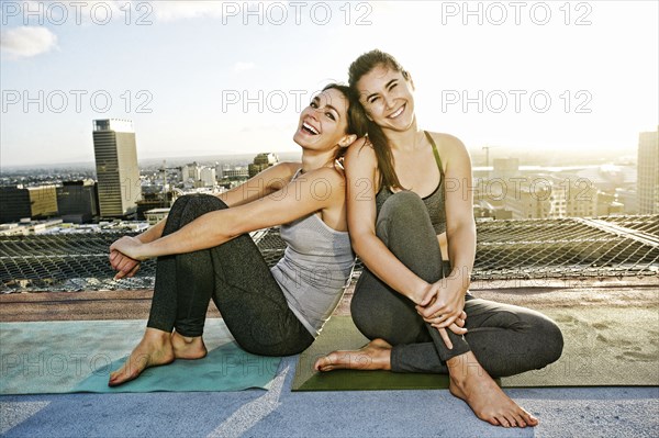 Caucasian woman relaxing urban rooftop after yoga