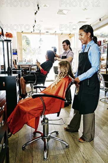 Hairdressers and customers in hair salon