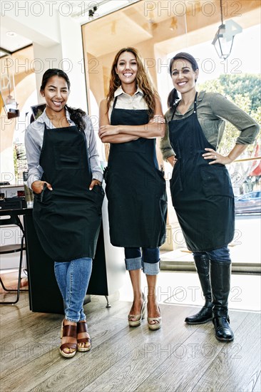 Smiling hairdressers posing in hair salon