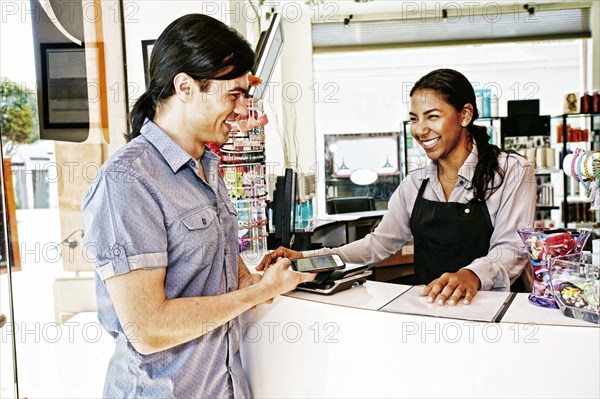 Customer paying in hair salon with cell phone