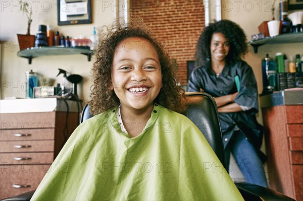 Smiling hairdresser and customer in hair salon