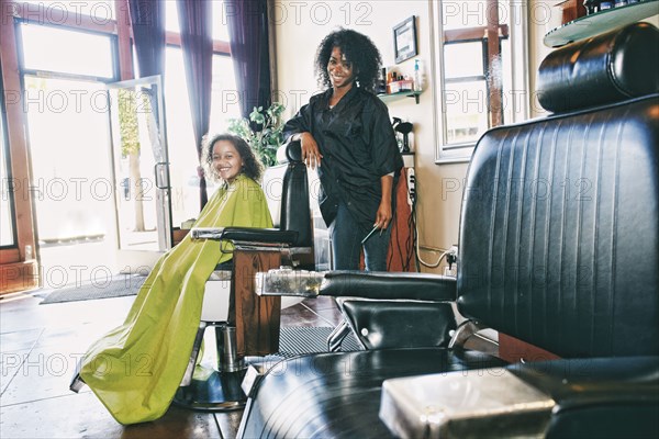 Smiling hairdresser and customer in hair salon