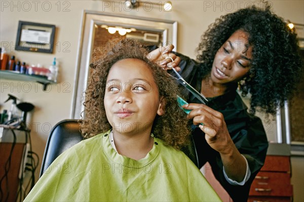 Smiling hairdresser and customer in hair salon