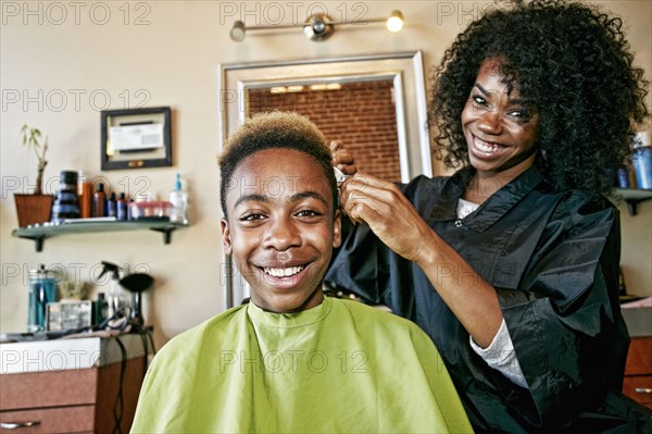 Smiling hairdresser and customer in hair salon