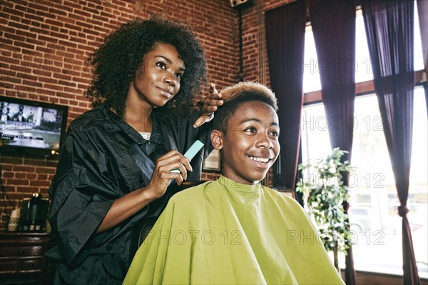 Smiling hairdresser and customer in hair salon