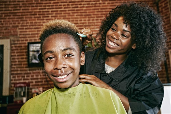 Smiling hairdresser and customer in hair salon