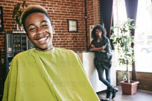 Smiling hairdresser and customer in hair salon