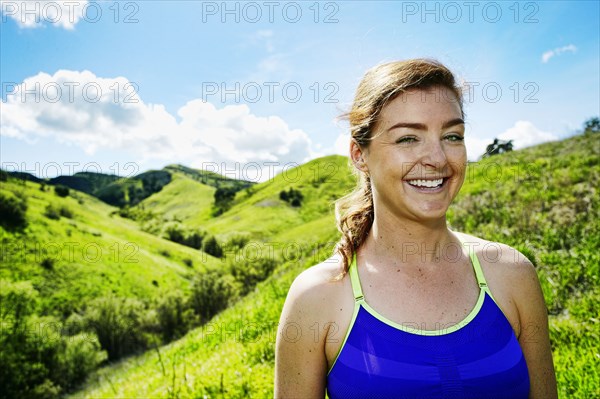 Smiling Caucasian woman posing on hill