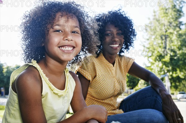 Mother and daughter smiling outdoors