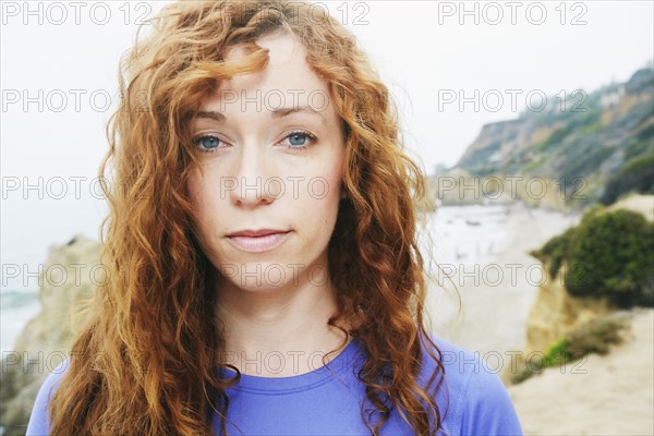 Serious Caucasian woman at beach