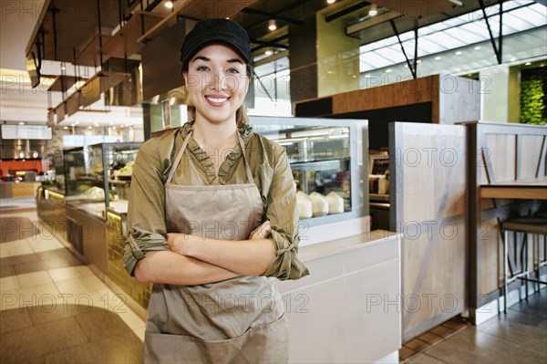 Portrait of smiling Mixed Race worker in food court