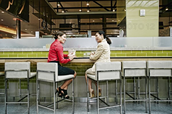 Smiling businesswomen talking in food court