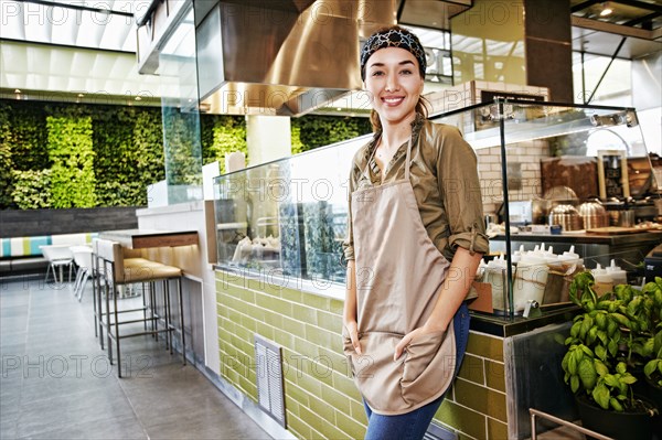 Portrait of smiling Mixed Race worker in food court