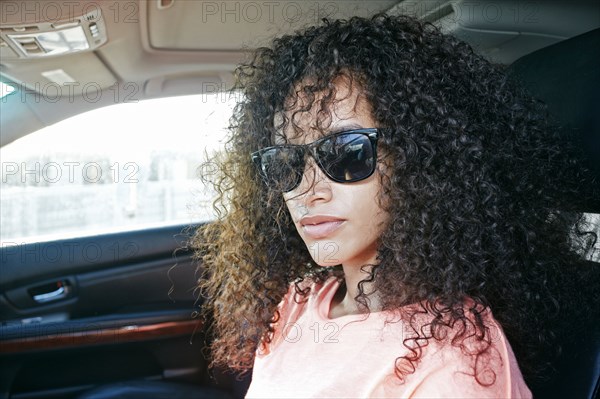 Portrait of Hispanic woman driving car