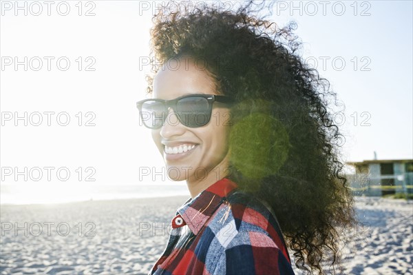 Portrait of smiling Hispanic woman at beach