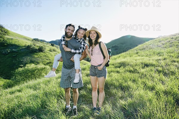 Portrait of happy family standing on hill