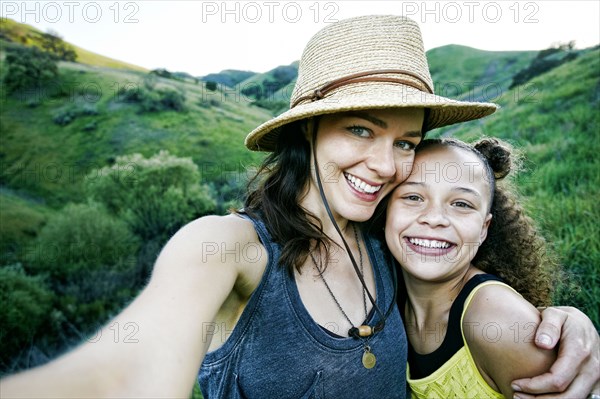 Mother and daughter posing for selfie