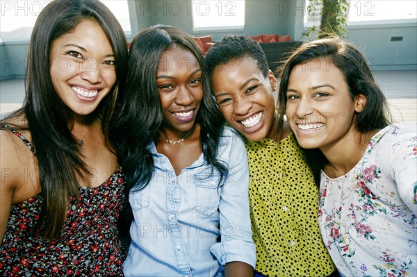 Smiling women posing on rooftop