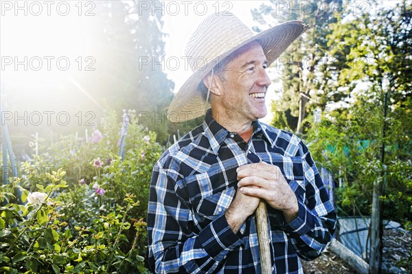 Smiling Caucasian man standing in garden