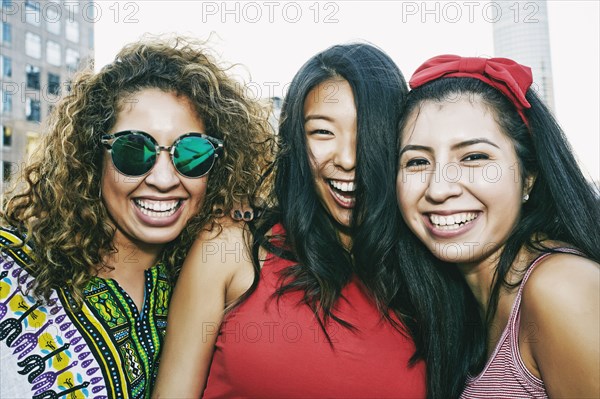 Portrait of women smiling on urban rooftop