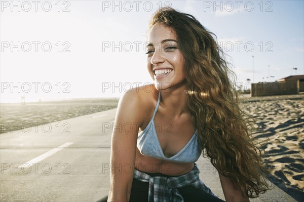 Portrait of Caucasian woman smiling on path at beach