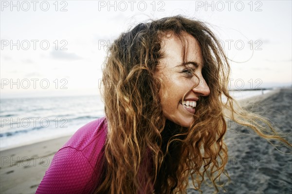 Wind blowing hair of Caucasian woman on beach