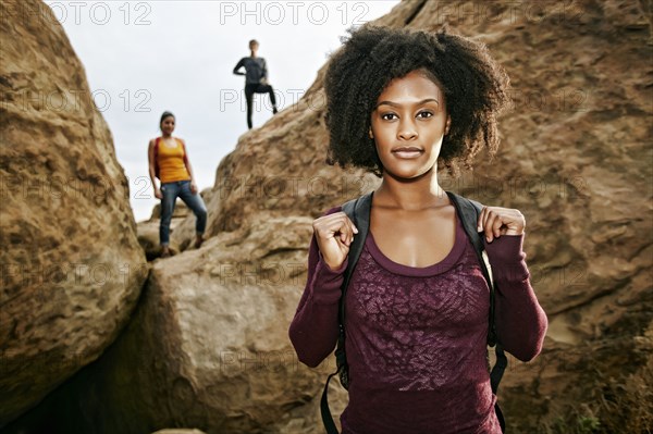 Portrait of serious woman posing near rock formation