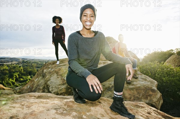 Portrait of smiling women posing on rock formation